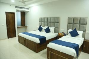 Postel nebo postele na pokoji v ubytování Hotel JD Regency