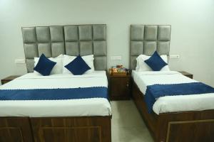 Postel nebo postele na pokoji v ubytování Hotel JD Regency