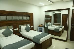 Postel nebo postele na pokoji v ubytování Hotel JD Regency