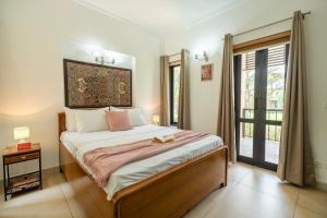 a bedroom with a large bed and a window at MiAmor by The StayCationer in Manesar
