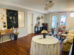 a living room with a table with flowers on it at Lily's garden in Charlottetown