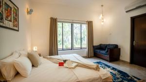 a bedroom with a large bed and a window at MiAmor by The StayCationer in Manesar