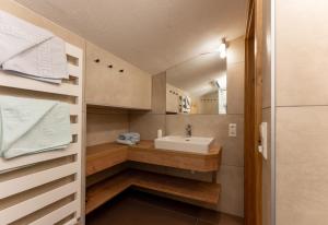 a small bathroom with a sink and a mirror at Pension Bergbauernhof Irxner in Schladming +155 photos