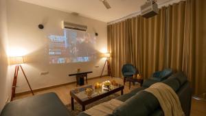 a living room with a couch and a tv at MiAmor by The StayCationer in Manesar +16 photos