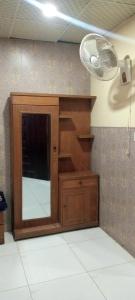 a room with a tv and a fan at Buttkarahi Hotel And Restaurant in Dargai