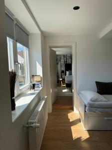 a room with a bed and a hallway with a window at Ferienhaus mit Terrasse in Buttelstedt