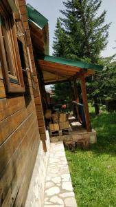 a porch of a house with a green roof at Vila Bianka Žabljak Vikendica u selu Uskoci in Žabljak +27 photos