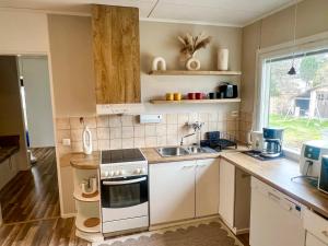 a kitchen with a sink and a stove top oven at Sunny Nest 2 Villa in Vaasa