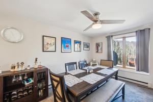 a dining room with a table and a ceiling fan at 46er 15E - Stylish & Comfortable Mountain Retreat in North Creek