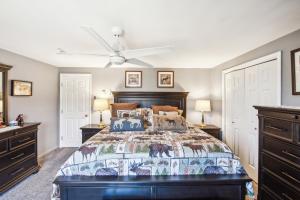 a bedroom with a large bed and two dressers at 46er 15E - Stylish & Comfortable Mountain Retreat in North Creek
