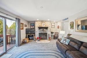 a living room with a couch and a fireplace at 46er 15E - Stylish & Comfortable Mountain Retreat in North Creek