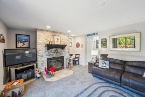 a living room with a couch and a fireplace at 46er 15E - Stylish & Comfortable Mountain Retreat in North Creek