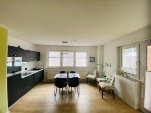 a kitchen with a table and chairs in a room at Susi's Seeblick in Waren