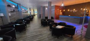 restauracja z szeregiem krzeseł i bar w obiekcie ALBERGUE A QUEIMADA Exclusivo Peregrinos w mieście Caldas de Reis +5 zdjęć