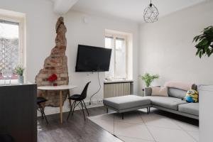 a living room with a couch and a tv at Modern & Renovated 1BR Apt in City Center in Helsinki +25 photos