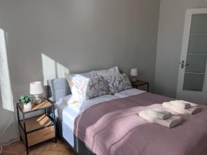 a bedroom with a bed with two towels on it at Reval Residences City Center in Tallinn