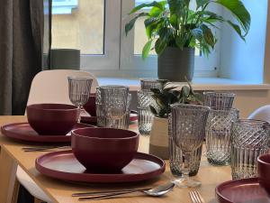 a table with plates and bowls and glasses on it at Reval Residences City Center in Tallinn +45 photos