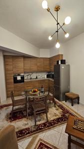 a kitchen with a table and a refrigerator at Guest House Siatista in Siátista
