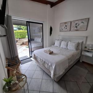 a bedroom with a bed and a large window at Sleep Haven Self-Catering Accommodation - Nelspruit in Nelspruit