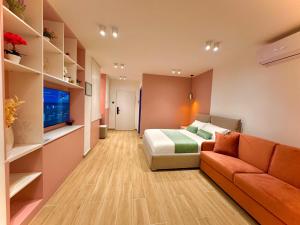 a hotel room with a bed and a couch at Elite Apartments in Durrës