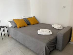 a bed with two towels on top of it at Triscele21 in Marina di Ragusa