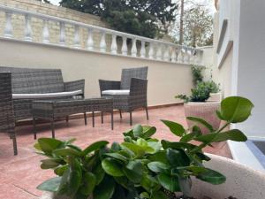 a patio with chairs and tables on a balcony at Downtown ViAlla in Chios