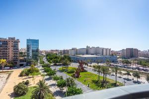 a view of a city with a statue in a park at Maya Bay Suites in Alicante