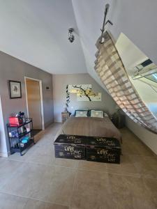 a bedroom with a large bed and a staircase at B&B Chez Séverine in Lamotte-Beuvron