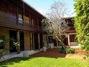 a building with a tree in front of it at No 05 Middle Street in Galle