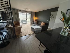 a living room with a couch and a table at Durbanville Self Catering Apartments in Durbanville +55 photos