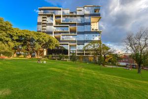 a tall building with a park in front of it at Park Central Residence - Building with Generator in Johannesburg