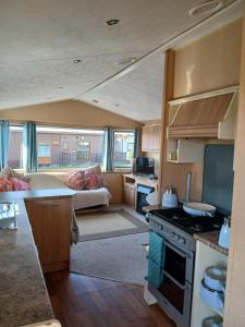 a living room with a kitchen and a caravan at L91 Rebecca's place in Mablethorpe