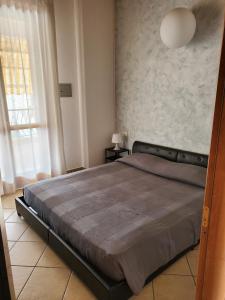 a bedroom with a large bed in a room at Villetta Imola in Lido degli Estensi