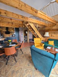 a living room with wooden ceilings and a blue couch at Noclegi Panorama - Domek RUSTIC in Ustrzyki Dolne