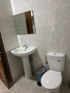 a bathroom with a toilet and a sink and a mirror at Azur in Tamraght Ouzdar