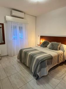 a bedroom with a large bed and a window at Casa en Santa Rosa in Santa Rosa