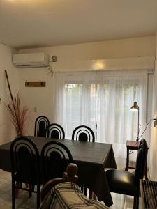 a dining room with a black table and chairs at Casa en Santa Rosa in Santa Rosa