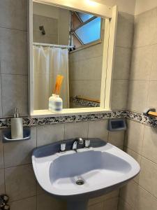 a white sink in a bathroom with a mirror at Casa en Santa Rosa in Santa Rosa