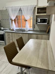 a kitchen with a wooden table and two chairs at Casa en Santa Rosa in Santa Rosa
