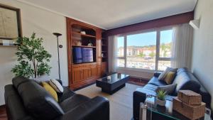 a living room with two couches and a large window at VISTAS MAR Y PUERTO Plentzia - 200m2 y Parking in Plentzia
