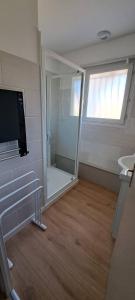 a bathroom with a mirror and a tv in a room at 45Quiri in Mont-de-Marsan