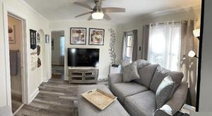 a living room with a couch and a flat screen tv at La Casita on Antique Row in West Palm Beach