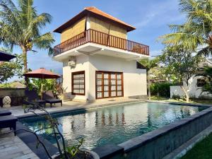 a villa with a swimming pool and a house at Villa Light - Amed Bali in Amed