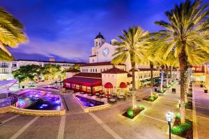 a town with palm trees and a large building at La Casita on Antique Row in West Palm Beach