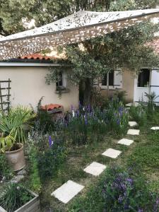 a garden in front of a house with flowers at Nuitée Naturopathique in La Rochelle +3 photos