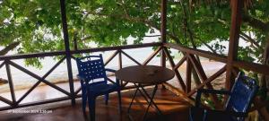 two chairs and a table on a porch at Asio Freewave Bungalows in Arawa