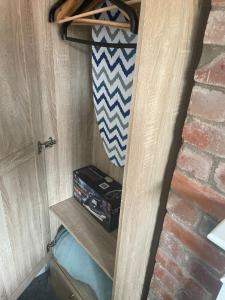 a room with a door with a surfboard on a shelf at Camaraderie Guest House in York