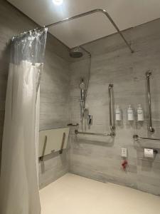 a shower in a bathroom with a shower curtain at Radisson Pinheiros in São Paulo