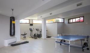 a gym with a ping pong table and exercise equipment at Hotel Doña Lola Zahara in Zahara de los Atunes