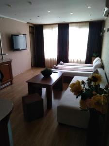 a living room with a couch and a table at Къща за гости Роси in Pomorie